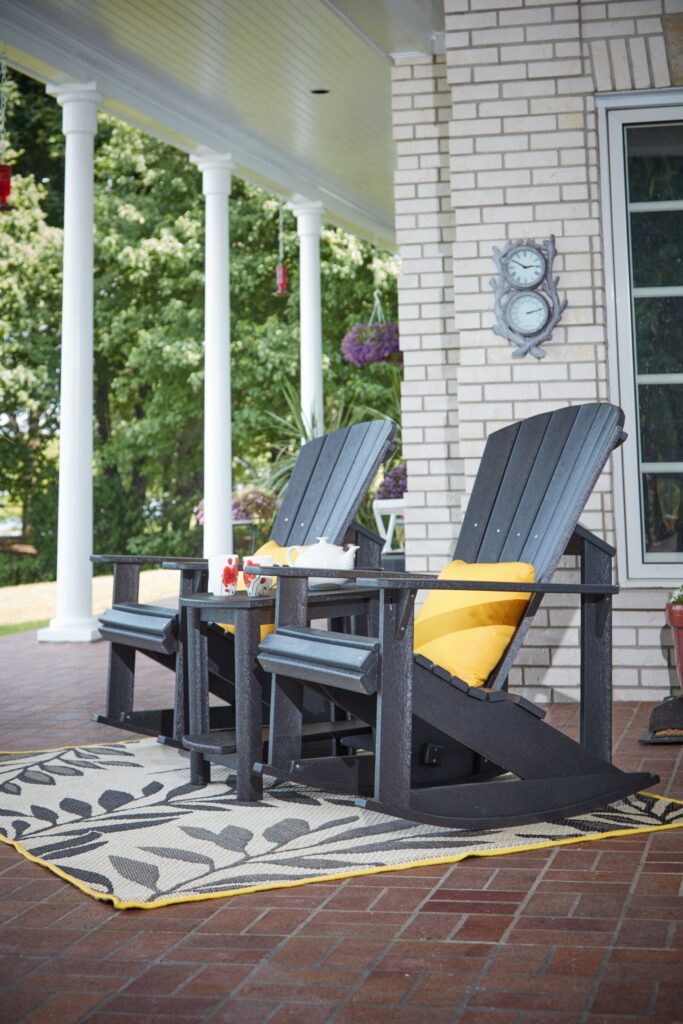 Slate Grey Generations Addy Side Table surrounded by two Slate grey Adirondack chairs