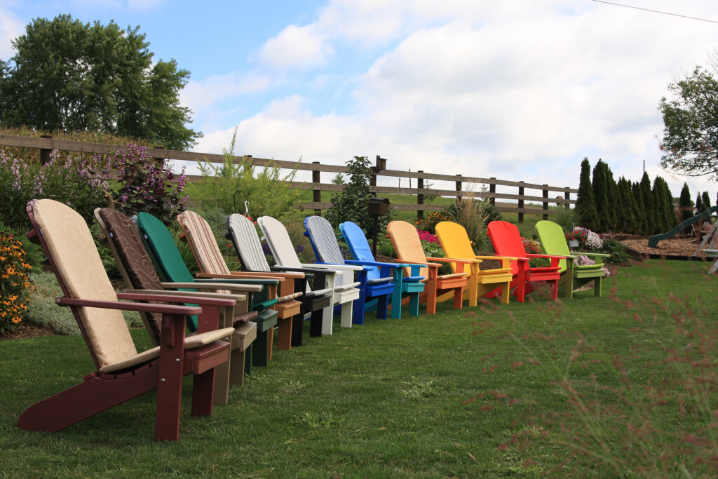 Assorted colors of Fanback Adirondack Chairs lined up