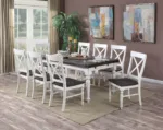 A dining table surrounded by chairs with the same finish as the X-Back Double Bench