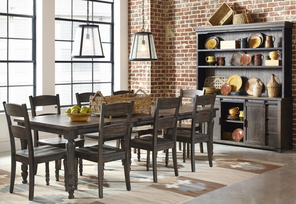 The Madison County Extension Table in Barnwood surrounded by chairs in a dining room