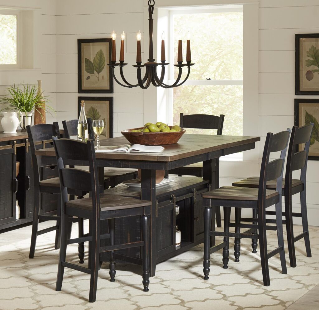 Madison County High/Low Extension Dining Table in Vintage Black with chairs surrounding it in a dining room.