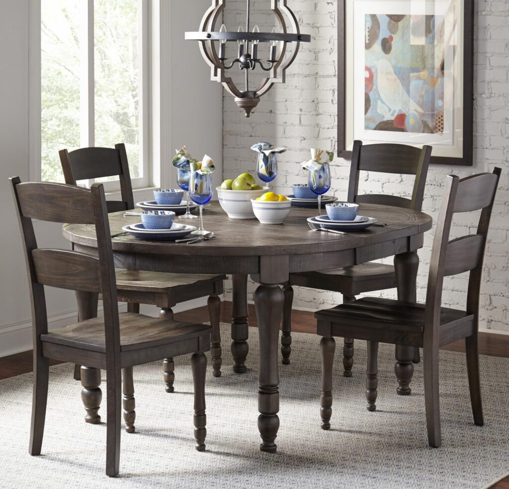 Madison County Round to Oval Dining Table in Barnwood with chairs surrounding it in a kitchen