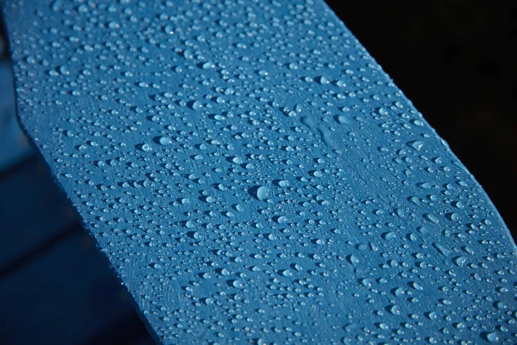 Up-close shot of rainwater on the earth friendly material that our Generations Premium Adirondack Footrest is made of